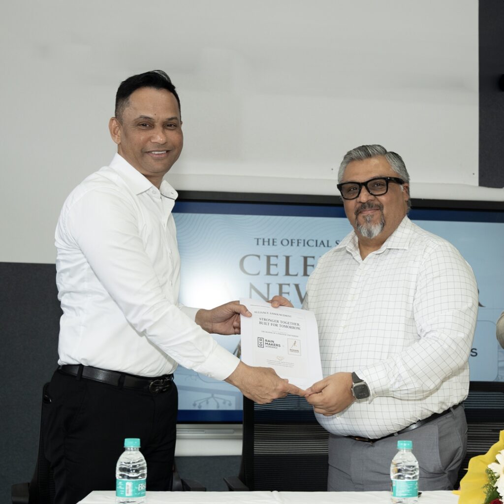 Dr. Rohan Monteiro and Mr. Praneesh Rao exchanging the partnership agreement at Rohan City, Mangaluru